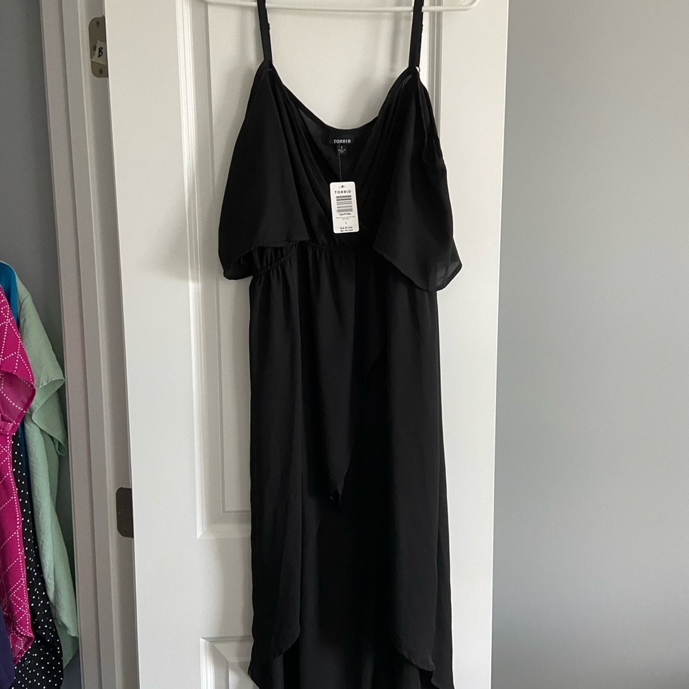 Black tong top, shorter in the front, cold shoulder adjustable strap